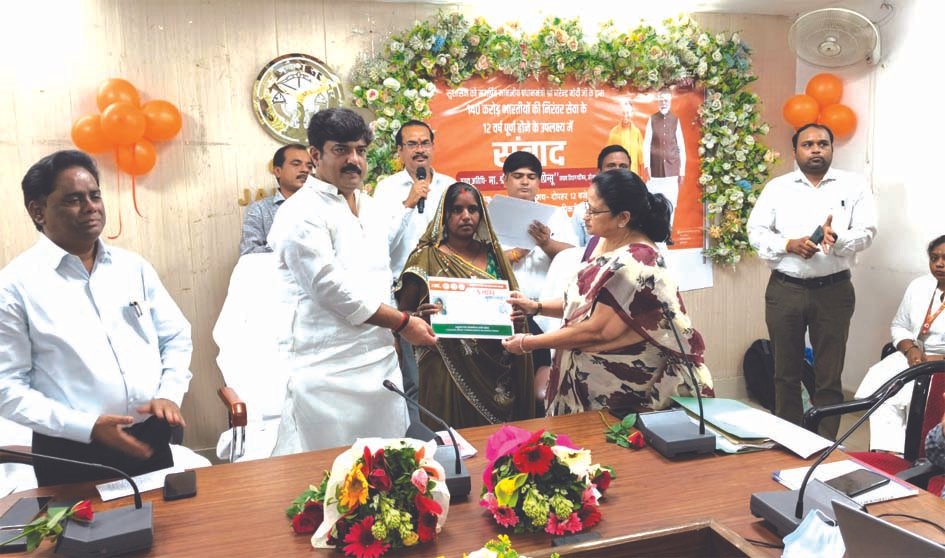 आयुष्मान कार्ड वितरण कार्यक्रम लाभार्थियों को आयुष्मान कार्ड वितरित करते अतिथि